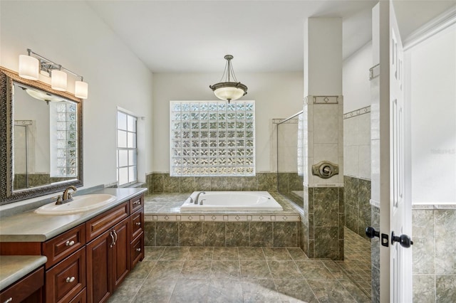 bathroom with vanity, a wealth of natural light, and independent shower and bath