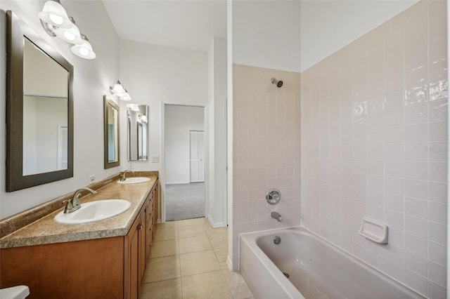 bathroom featuring tile patterned floors, vanity, and tiled shower / bath