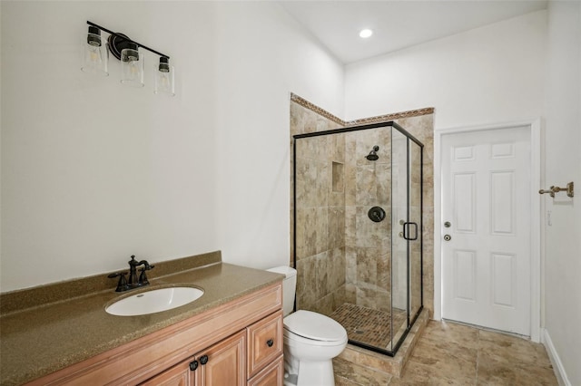 bathroom featuring vanity, toilet, and walk in shower