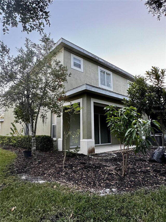 8550 Trail Wind Dr, Tampa, FL 33647 - back of house featuring stucco siding