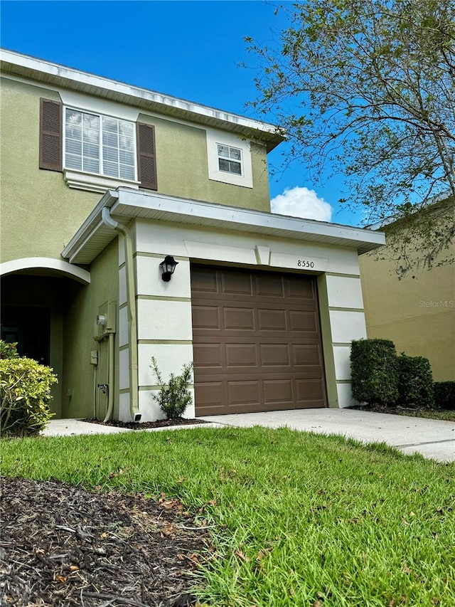 exterior space featuring an attached garage and stucco siding