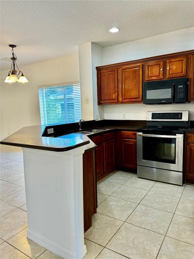 kitchen featuring stainless steel range oven, a textured ceiling, light tile patterned floors, and kitchen peninsula