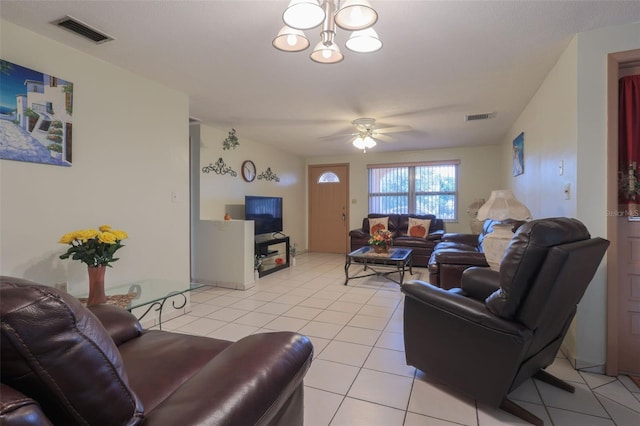 living room with light tile patterned floors and ceiling fan with notable chandelier