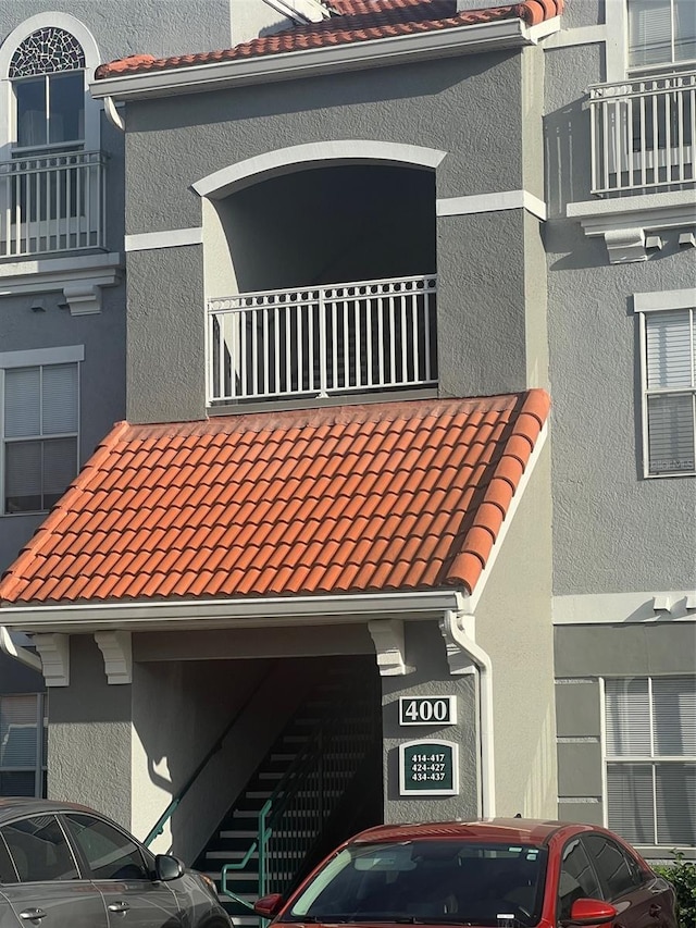 18001 Richmond Place Dr Unit 425, Tampa, FL 33647 - exterior view of a tiled roof, stucco siding, a downspout, and gutters