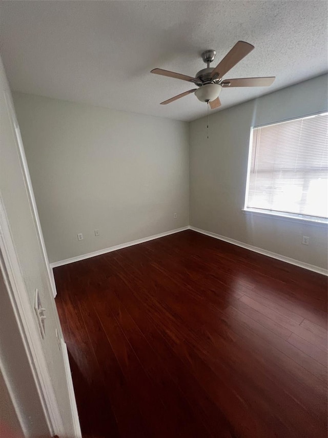 unfurnished room featuring a textured ceiling, dark hardwood / wood-style flooring, and ceiling fan