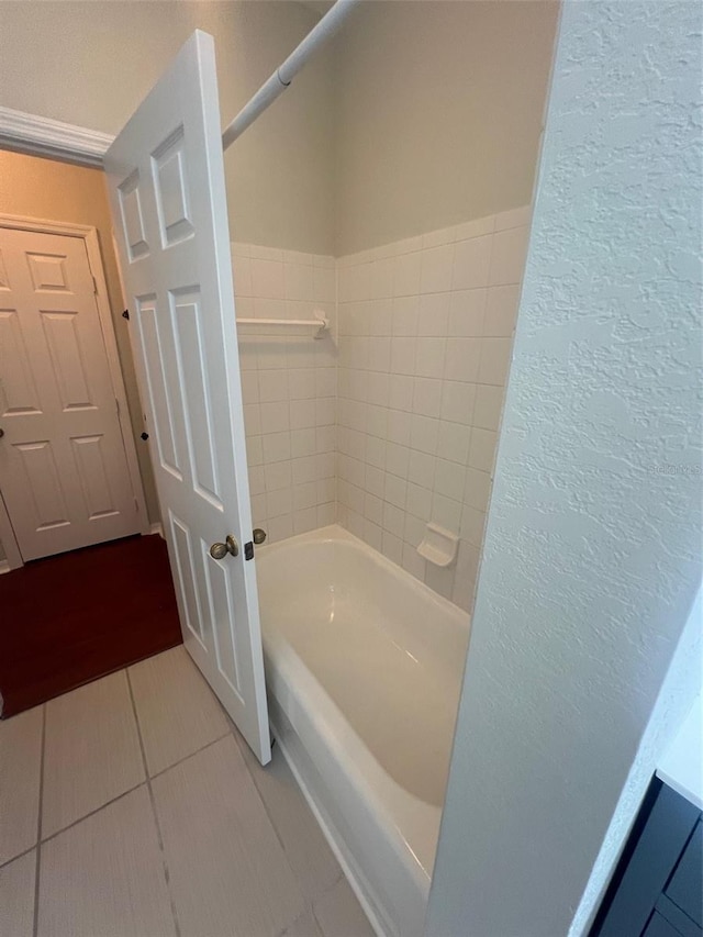 bathroom with a washtub and tile patterned floors