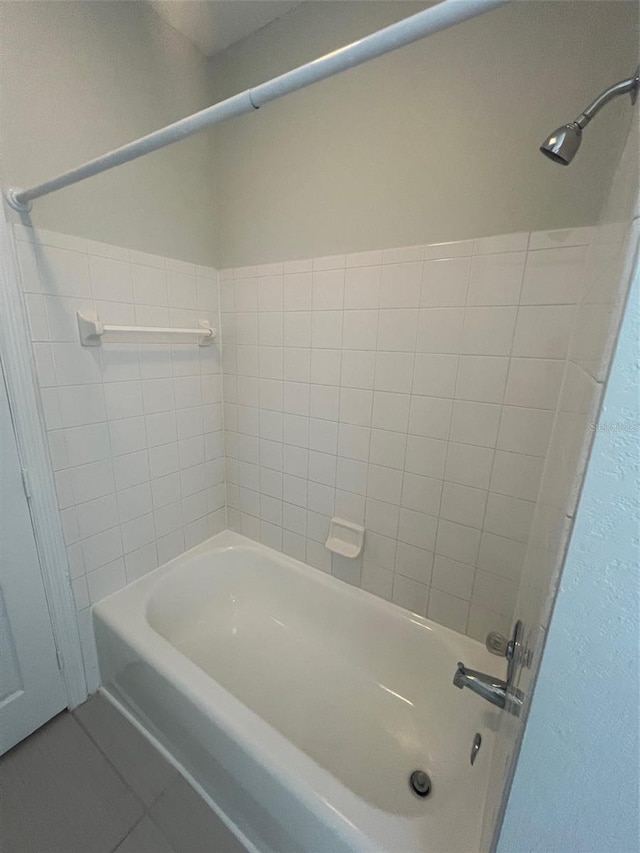 bathroom with tile patterned flooring and tiled shower / bath combo