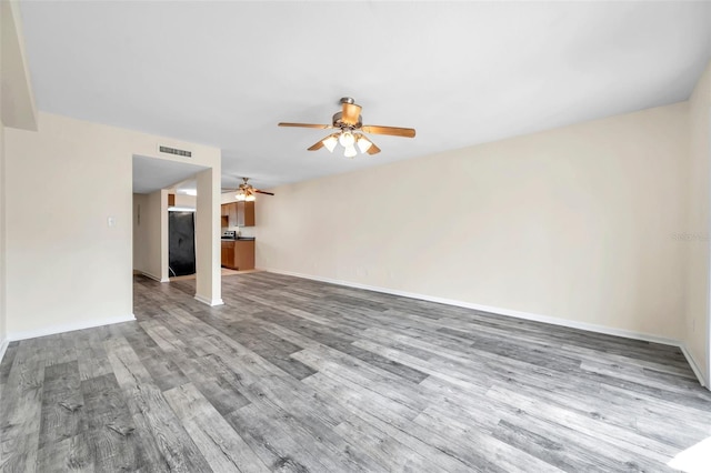 unfurnished living room with hardwood / wood-style floors and ceiling fan