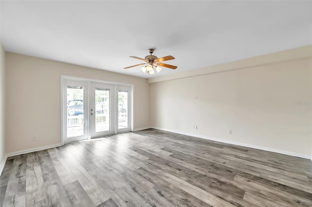 unfurnished room with ceiling fan and wood-type flooring