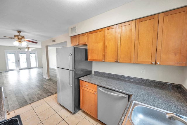 kitchen with ceiling fan, sink, light hardwood / wood-style floors, french doors, and stainless steel appliances