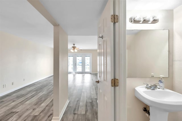 bathroom featuring french doors, sink, wood-type flooring, and ceiling fan