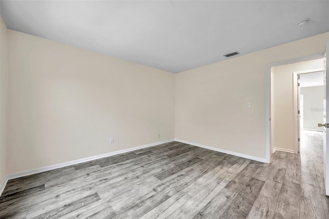 spare room with light hardwood / wood-style flooring