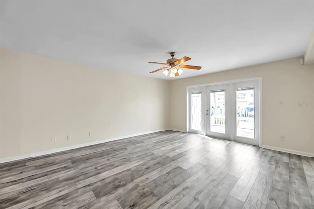 spare room with light hardwood / wood-style flooring, french doors, and ceiling fan