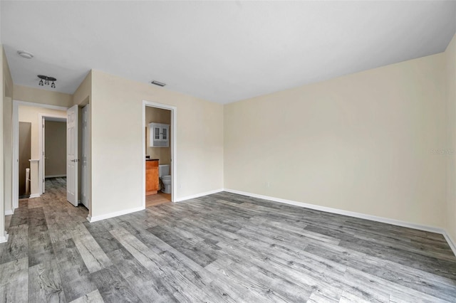 spare room with hardwood / wood-style flooring