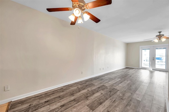 empty room featuring hardwood / wood-style floors, french doors, and ceiling fan