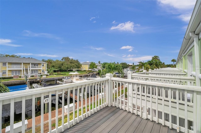 wooden terrace featuring a water view