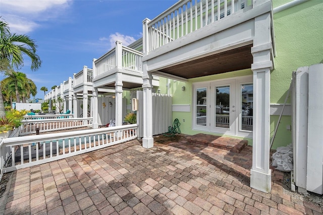 view of patio / terrace with french doors and a balcony