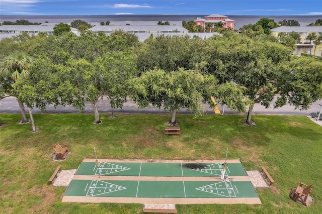 view of community with a yard and a water view