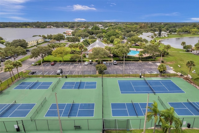 view of tennis court with a water view