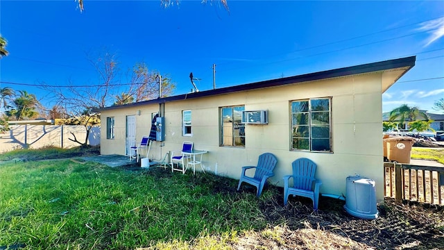 rear view of house featuring a yard