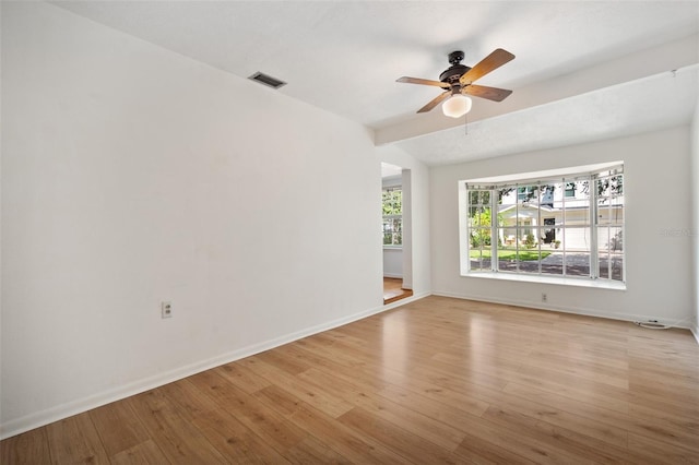 unfurnished living room with ceiling fan, light hardwood / wood-style flooring, and lofted ceiling with beams