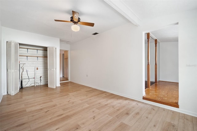 unfurnished bedroom with beam ceiling, ceiling fan, and light wood-type flooring