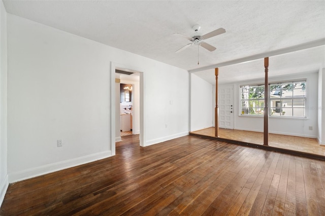 unfurnished bedroom featuring ceiling fan, a closet, wood-type flooring, and a textured ceiling