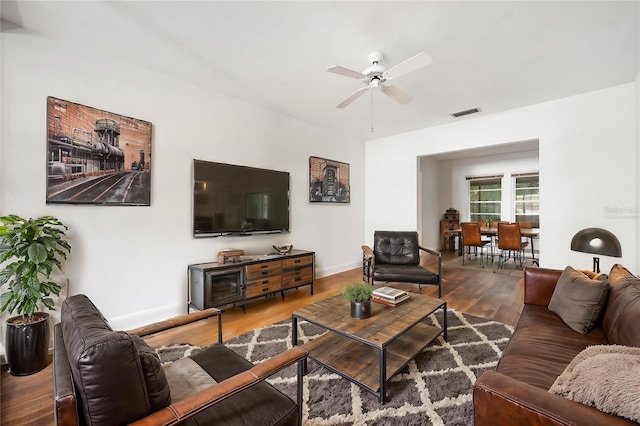 living room featuring ceiling fan and wood-type flooring