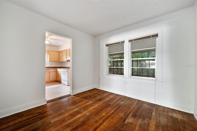 unfurnished room with dark hardwood / wood-style flooring and ceiling fan