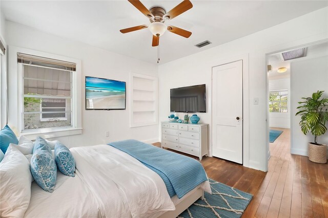 bedroom with ceiling fan and dark hardwood / wood-style floors