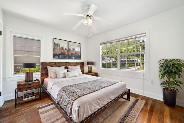 bedroom with ceiling fan and dark hardwood / wood-style floors