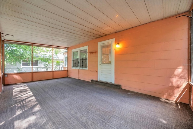 unfurnished sunroom with wood ceiling