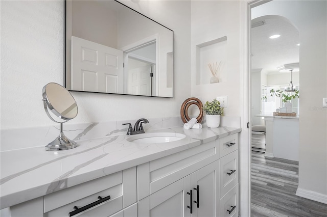 bathroom with vanity and hardwood / wood-style flooring