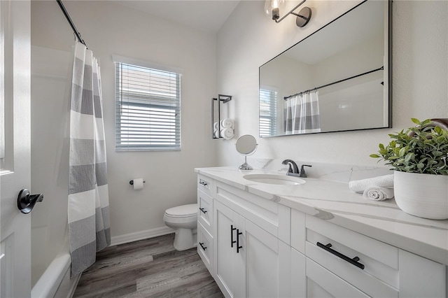 bathroom featuring vanity, curtained shower, wood-type flooring, and toilet