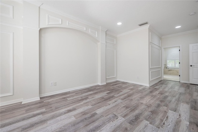 unfurnished room with light hardwood / wood-style flooring and crown molding