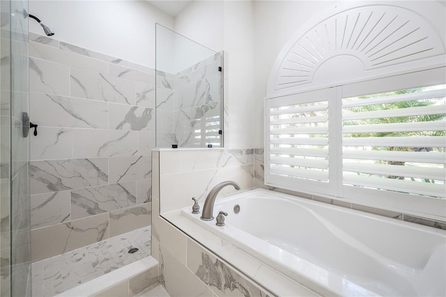 bathroom featuring separate shower and tub