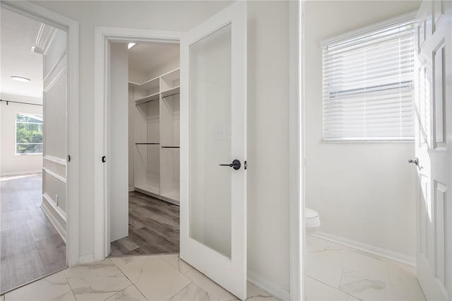 bathroom with toilet and hardwood / wood-style flooring