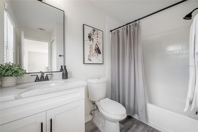 full bathroom with vanity, shower / bath combo with shower curtain, hardwood / wood-style flooring, and toilet