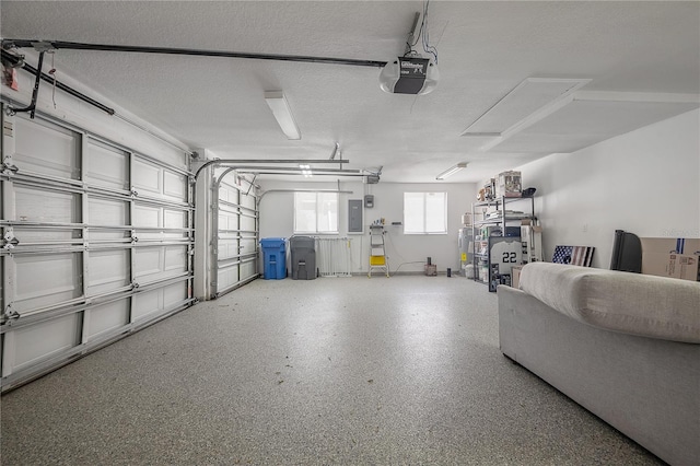 garage featuring a garage door opener and electric panel