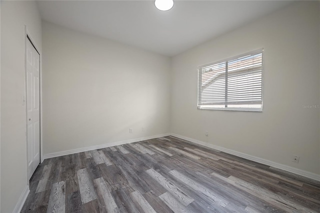 unfurnished room featuring dark wood-type flooring