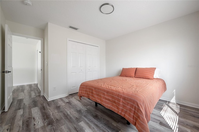 bedroom featuring a closet and dark hardwood / wood-style flooring