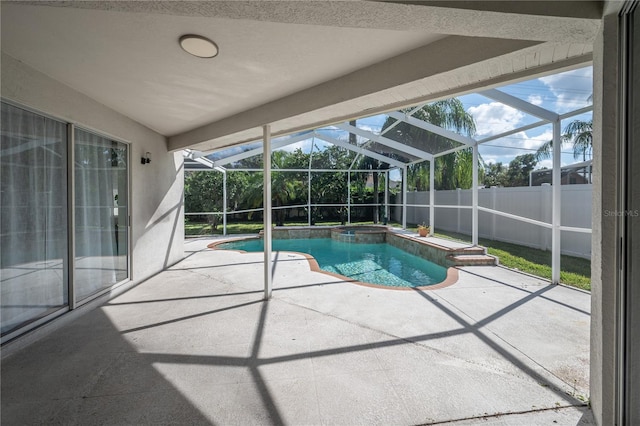 view of pool featuring a patio area and glass enclosure