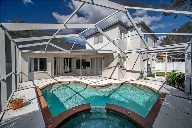 view of swimming pool featuring a patio area, a lanai, and an in ground hot tub