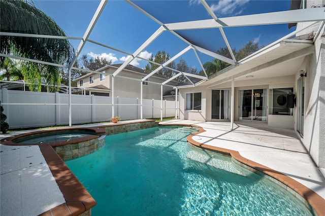 view of swimming pool with an in ground hot tub, a patio, and a lanai