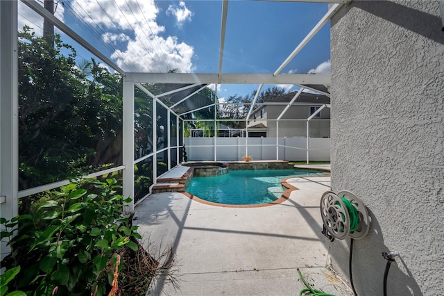 view of pool with a patio and glass enclosure