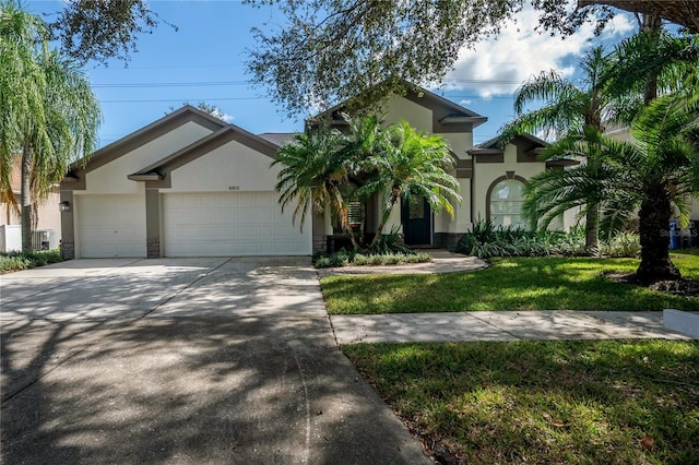 view of front of property with a front yard and a garage