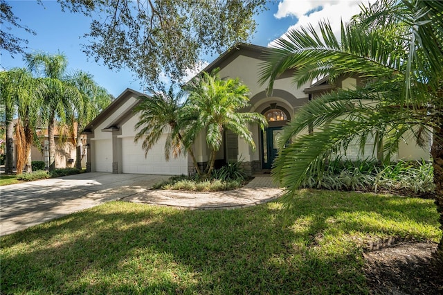 mediterranean / spanish house with a front lawn and a garage