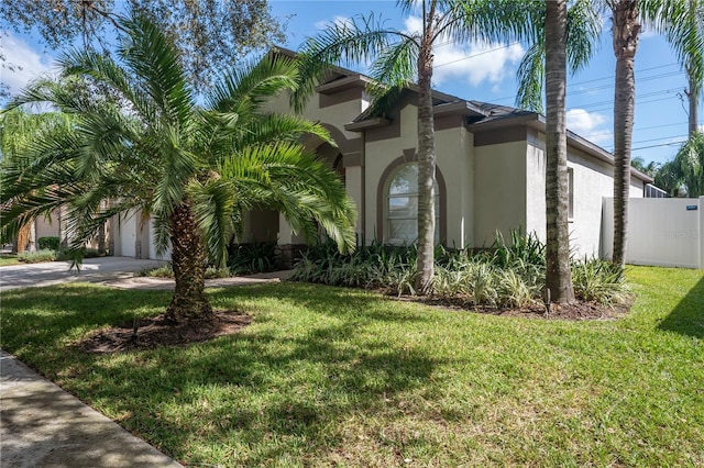 view of side of property featuring a yard and a garage