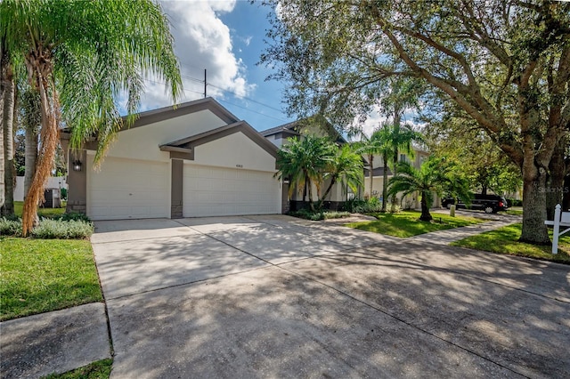 view of front of home featuring central AC unit and a garage