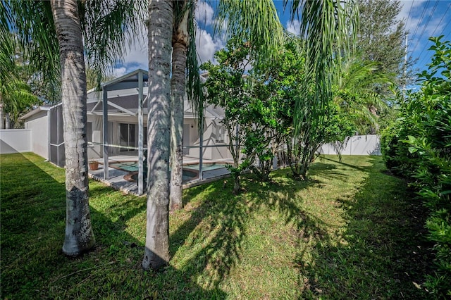 view of yard with a fenced in pool and a lanai